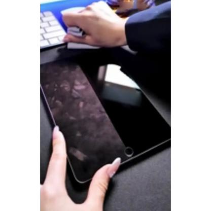 Black tablet with a textured, dark surface and rounded corners.