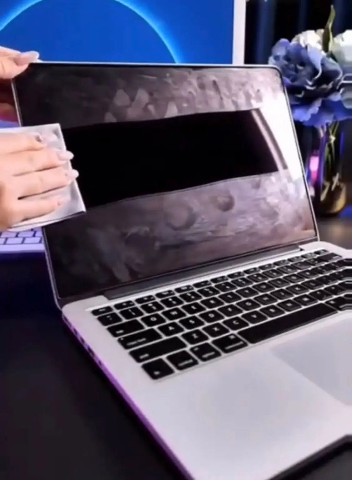 Silver laptop with a black and gray camouflage-patterned screen protector