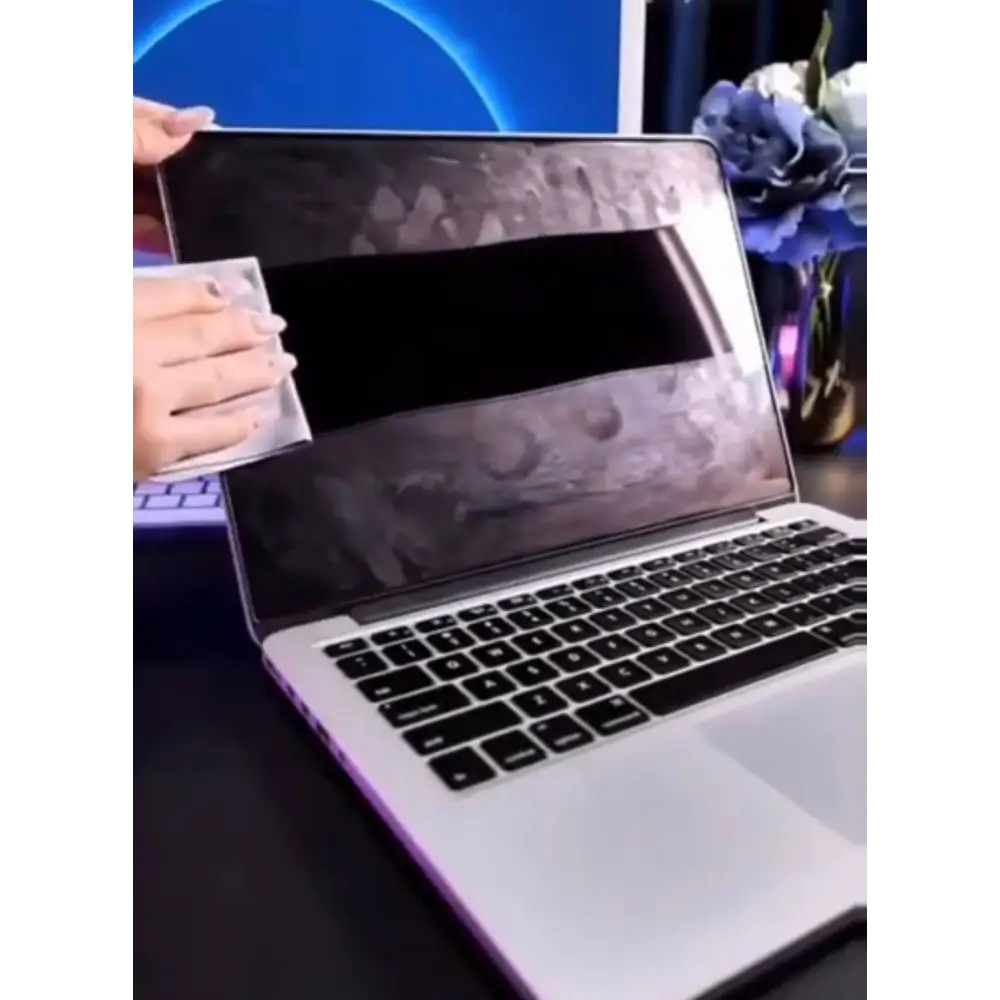 Silver laptop with a black and gray camouflage-patterned screen protector