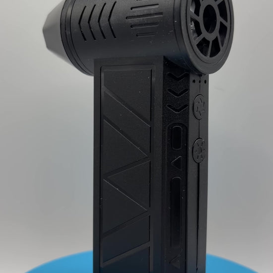 Rechargeable Mini Turbo Air Duster With LED Light rotating on a blue pedestal