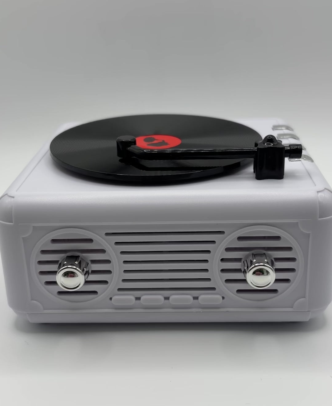 a white retro vinyl record player bluetooth speaker playing music