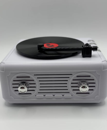 a white retro vinyl record player bluetooth speaker playing music