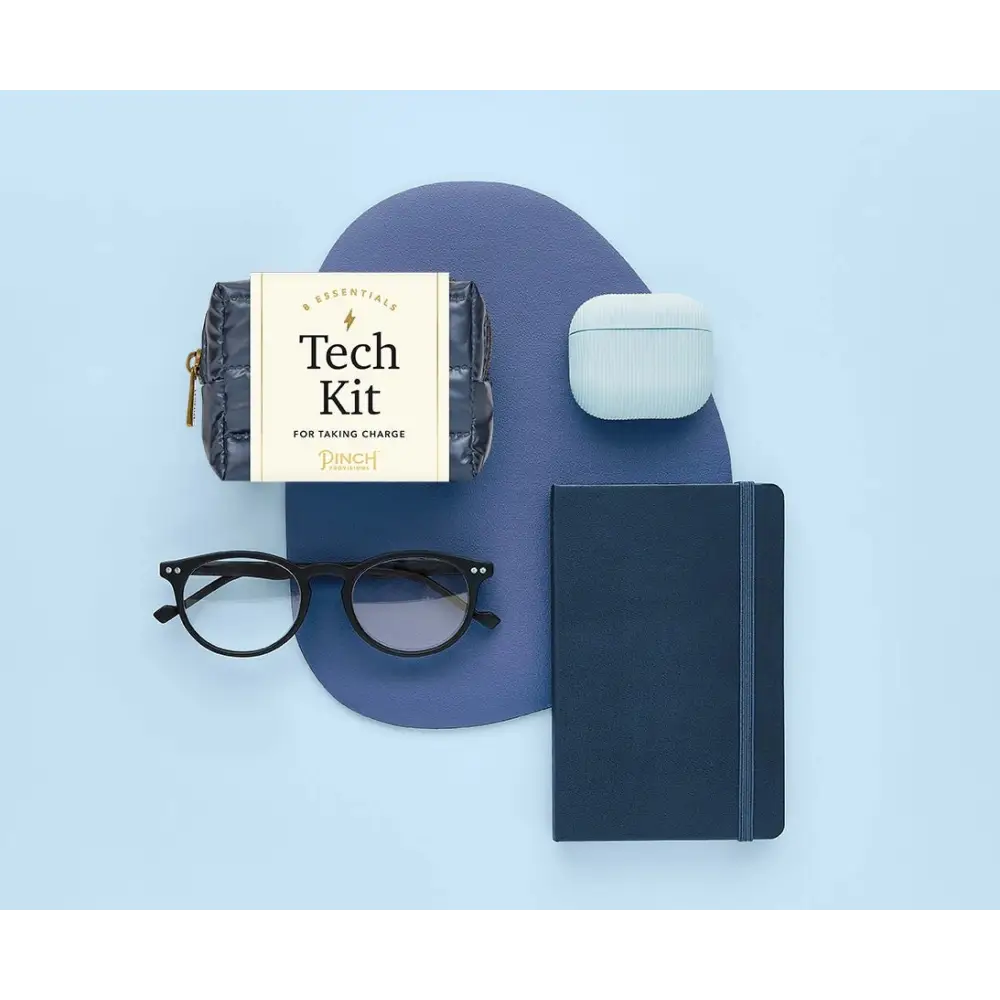 Dark blue quilted pouch labeled ’tech kit’ by pinch.