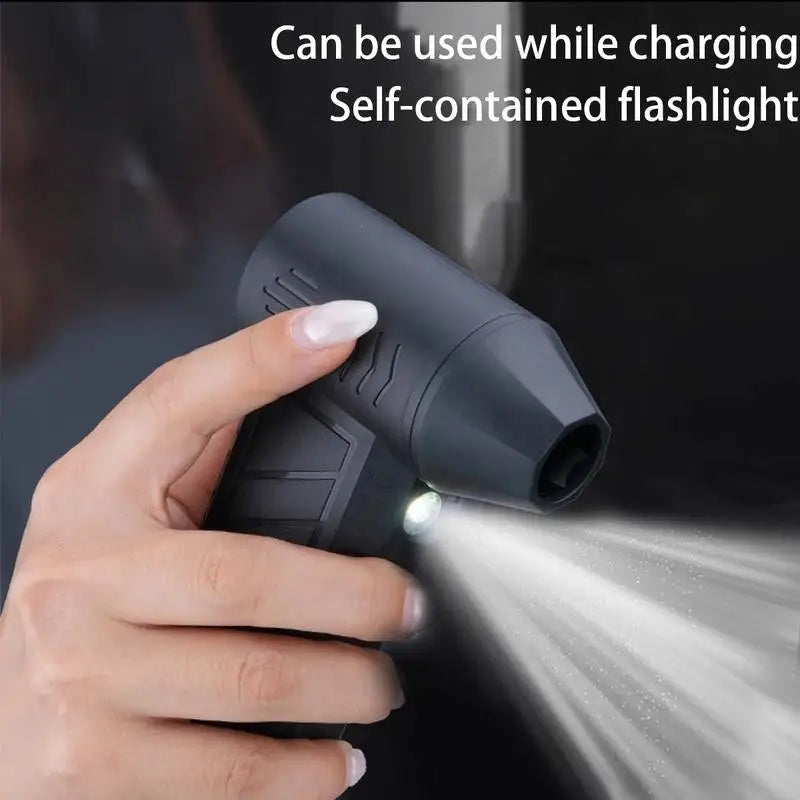 Black rechargeable mini turbo blower air duster with textured grip and LED light emitting bright beam for cleaning
