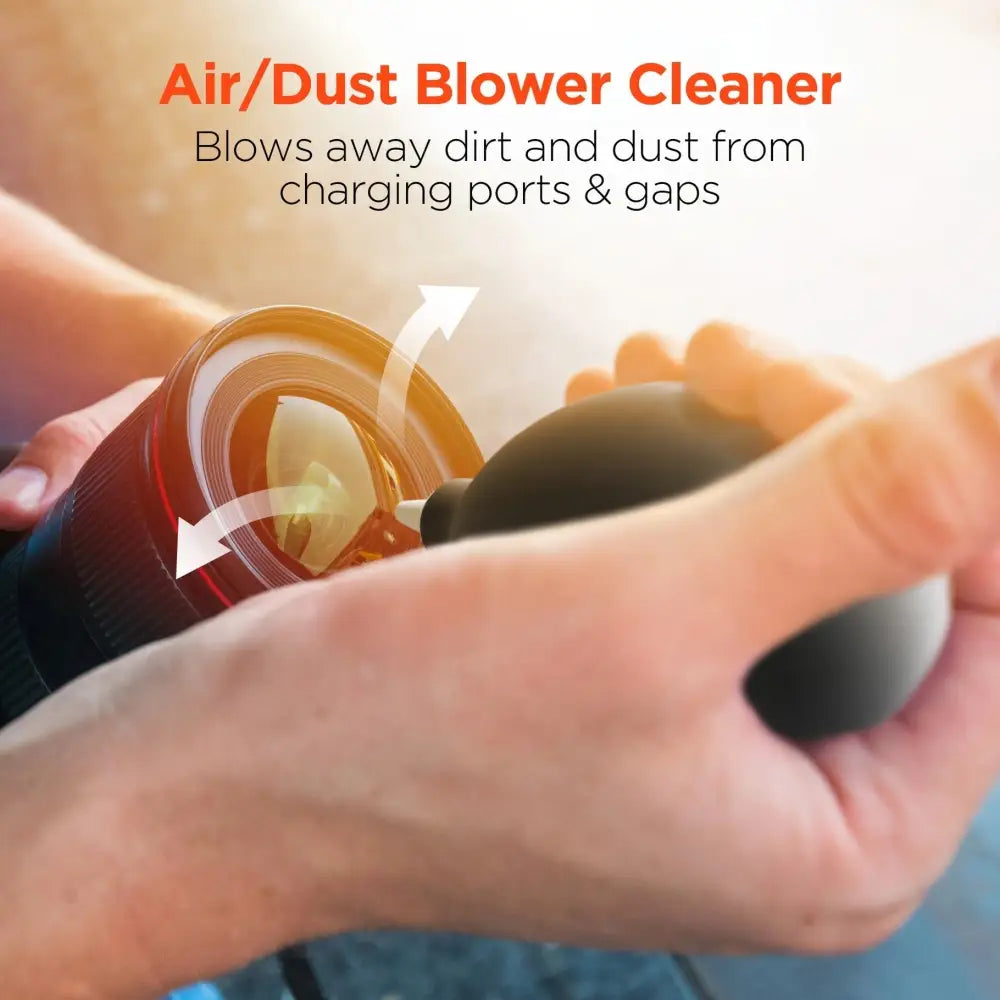 Black air/dust blower cleaner being used to clean a camera lens
