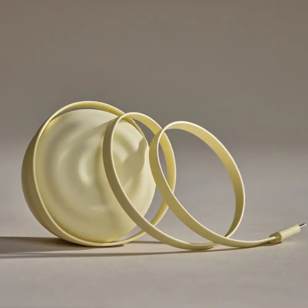 Cream-colored, sleek, minimalist charging cable with a rounded, flexible design and a usb-c connector.
