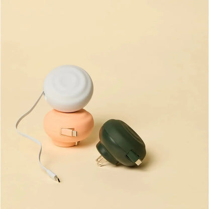 Pastel-colored, compact portable power banks with rounded plastic bodies and integrated usb-c cables.