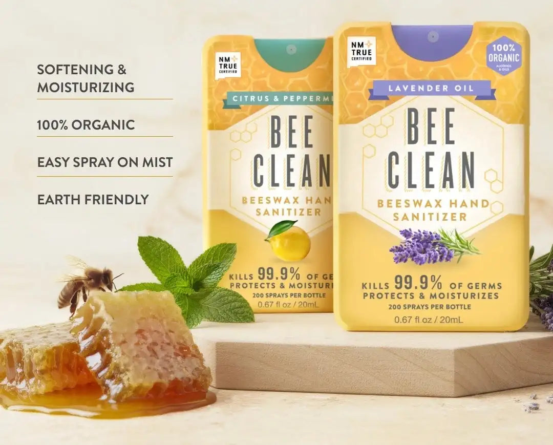 Yellow rectangular bottles of bee clean beeswax hand sanitizer with honeycomb and floral design.